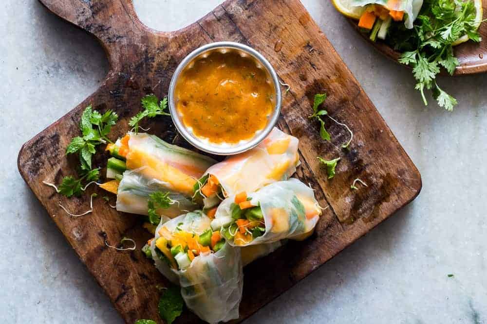 These mango bell pepper rice paper rolls are the perfect summer food - stuffed with lots of fresh veggies and served with an insanely delicious mango cilantro dipping sauce! Naturally gluten free, vegan and low carb!