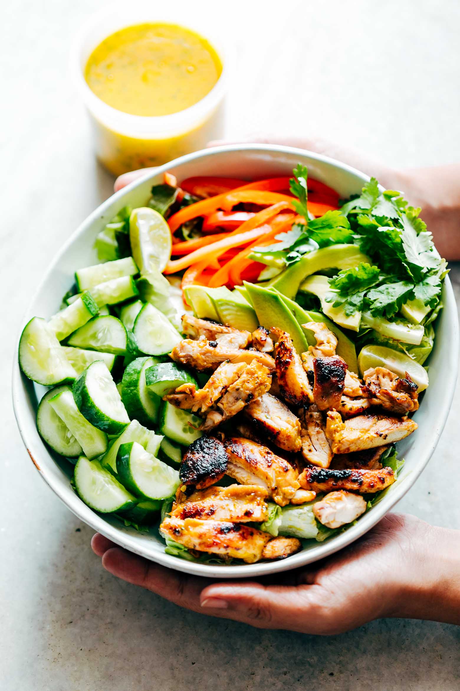 Grilled Chicken Mango Salad with Mango Cilantro Dressing is loaded with cucumbers, peppers, avocado and has a crazy good dressing that doubles up as a marinade!  Best summer salad ever!