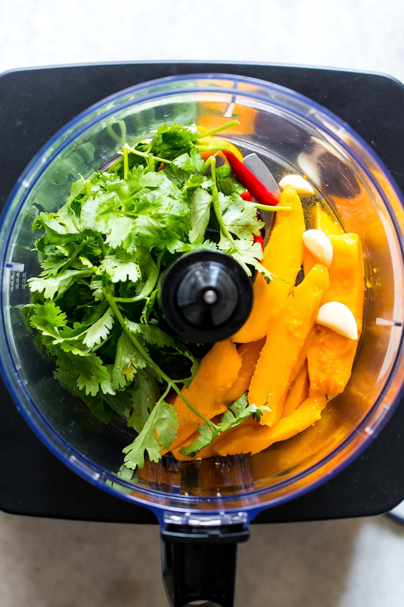 Mango Cilantro Salad Dressing is a fresh, tropical, creamy dressing that's super healthy, easily made in a blender and is gluten free. You'll want to pour it on everything!
