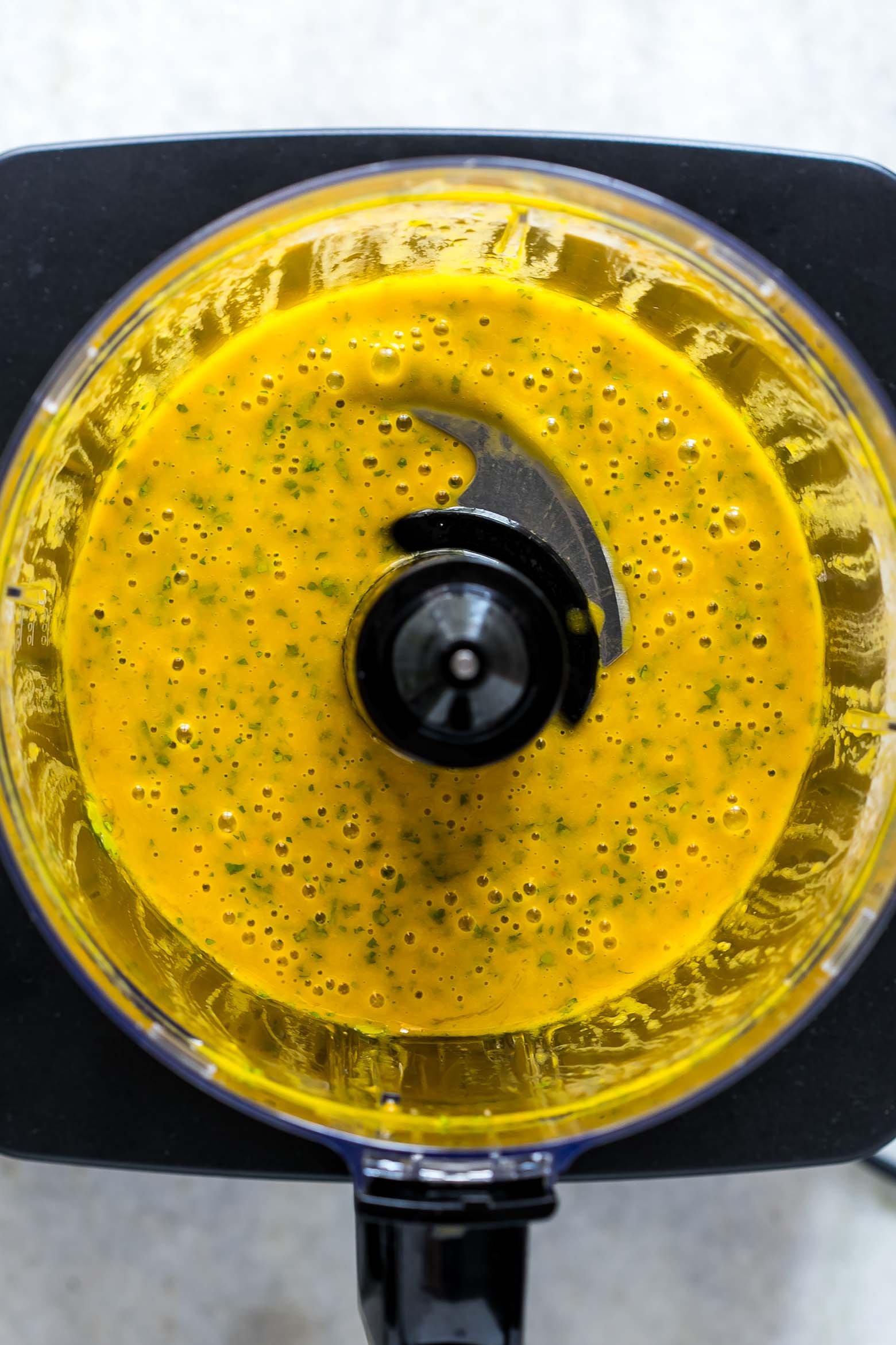 Mango Cilantro Salad Dressing is a fresh, tropical, creamy dressing that's super healthy, easily made in a blender and is gluten free. You'll want to pour it on everything!
