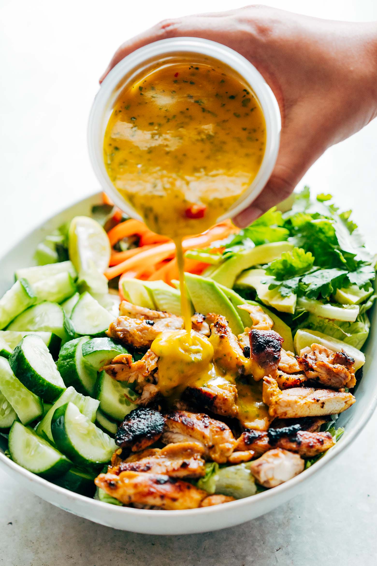 Grilled Chicken Mango Salad with Mango Cilantro Dressing is loaded with cucumbers, peppers, avocado and has a crazy good dressing that doubles up as a marinade!  Best summer salad ever!