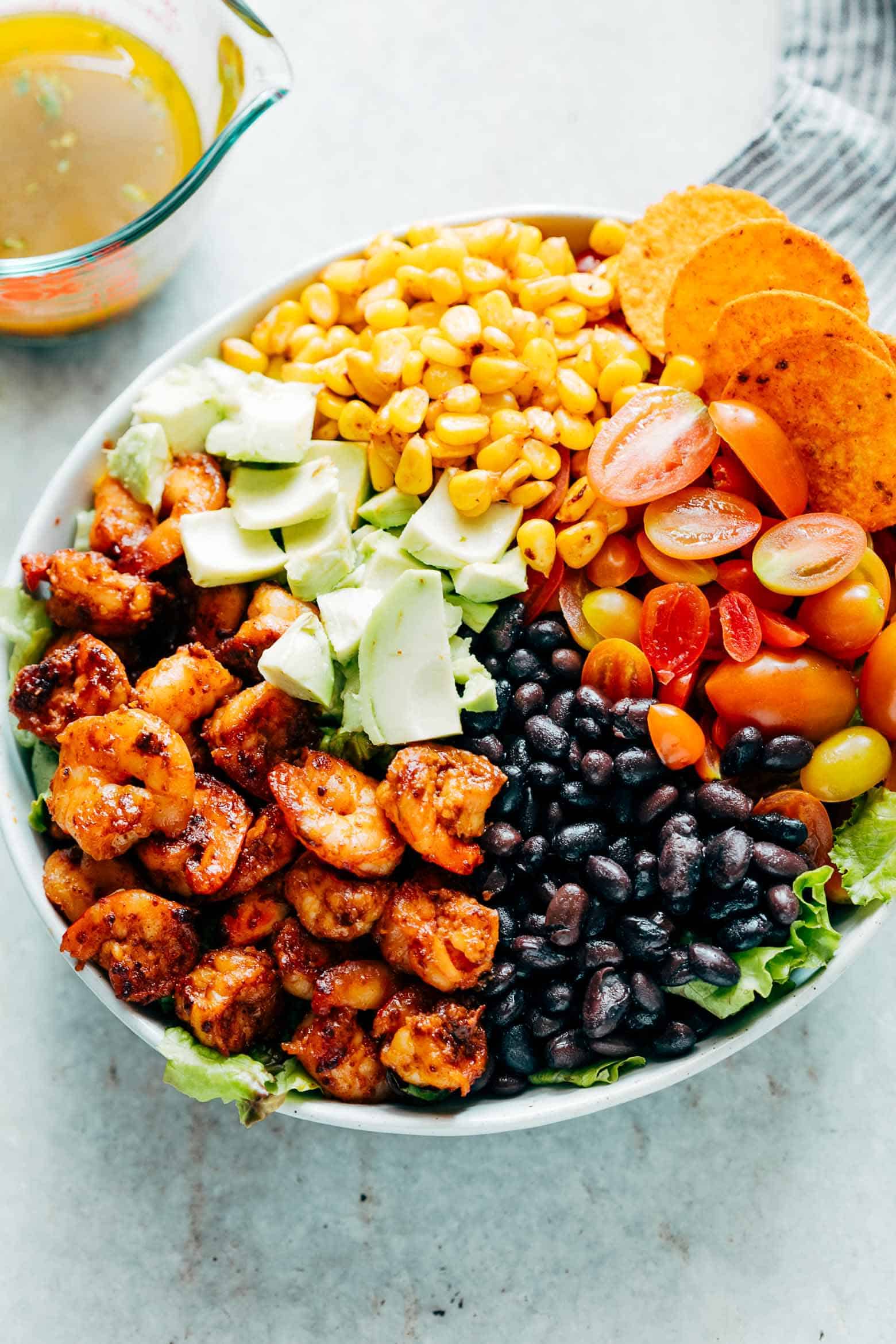 Mexican Prawn Avocado Taco Salad is a delicious, hearty salad that has all the flavours of your favourite mexican taco, but healthier. Loaded with lettuce, black beans, avocado, cherry tomatoes and a delicious cilantro lime dressing, it's perfect when you want salad for dinner.