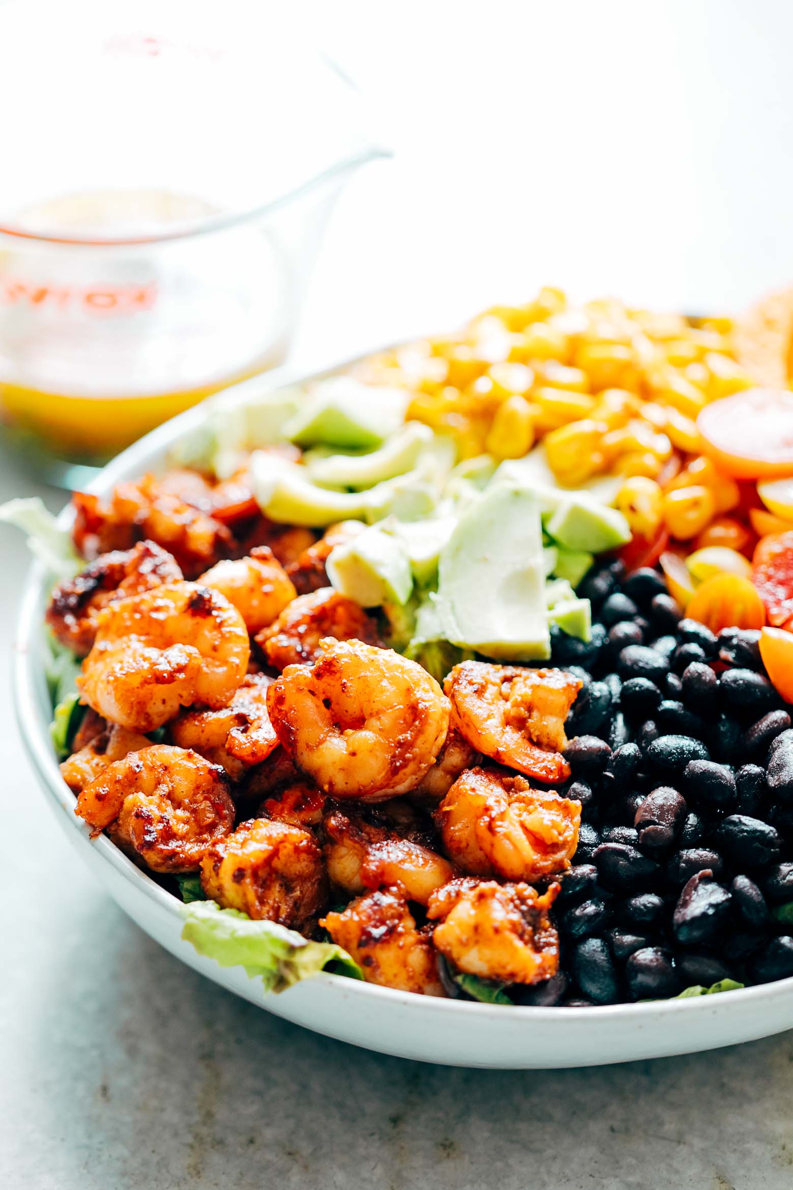 Mexican Prawn Avocado Taco Salad is a delicious, hearty salad that has all the flavours of your favourite mexican taco, but healthier. Loaded with lettuce, black beans, avocado, cherry tomatoes, corn and a delicious cilantro lime dressing, it's perfect when you want salad for dinner.